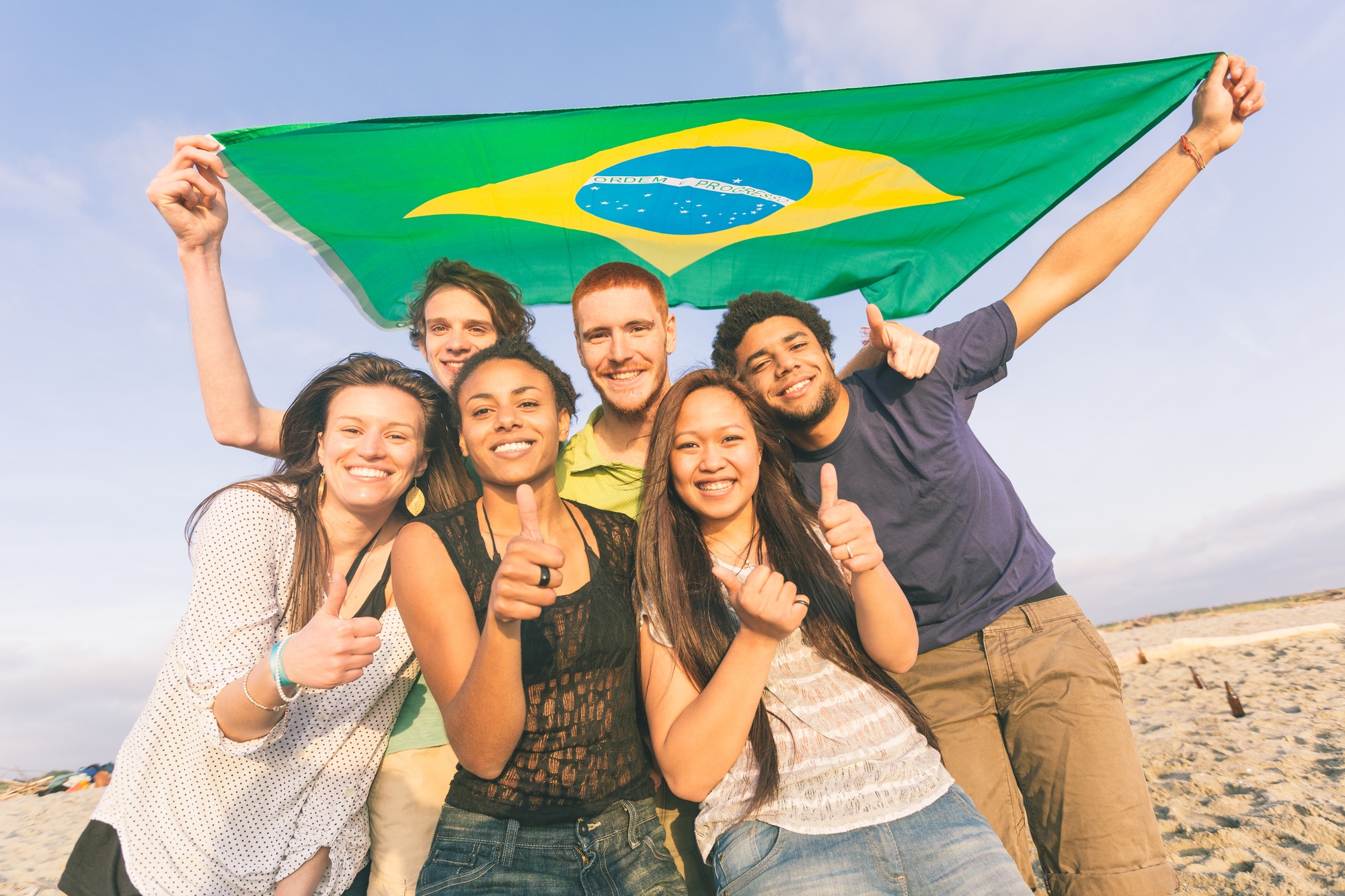 Group of Friends with Brazilian Flag at Beach